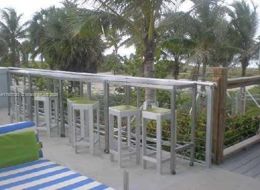 9401 Collins Avenue, Unit 801 Surfside, FL 33154 - Photo 46 of 51 a view of a chair and table in the patio