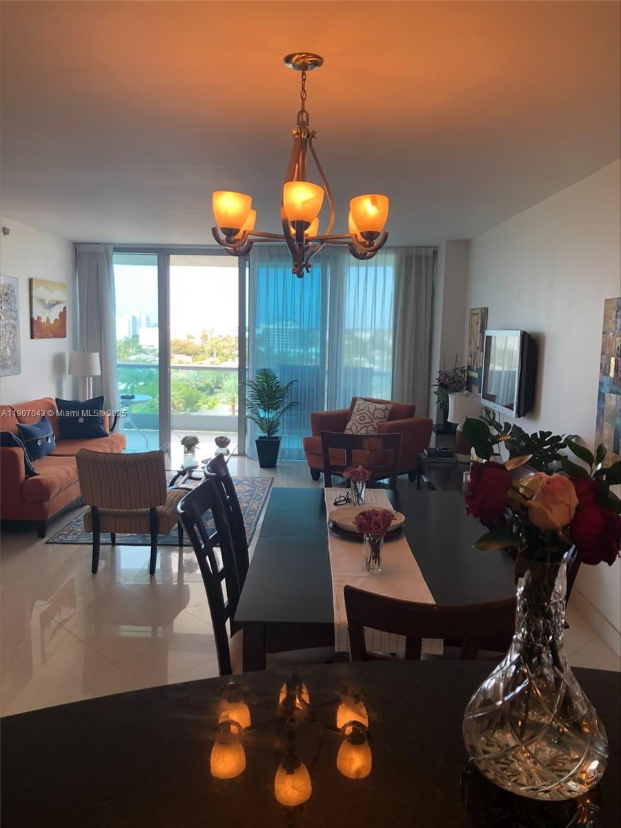 9401 Collins Avenue, Unit 801 Surfside, FL 33154 - Photo 7 of 51 a living room with furniture a floor to ceiling window and rug