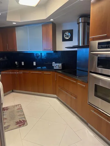 a kitchen with granite countertop a stove and a microwave
