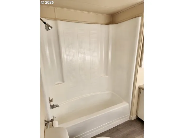 a bathroom with a bathtub and a shower