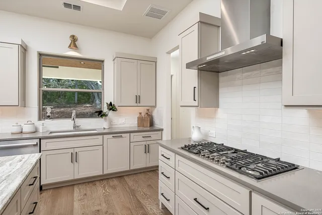 a kitchen with white cabinets and white appliances