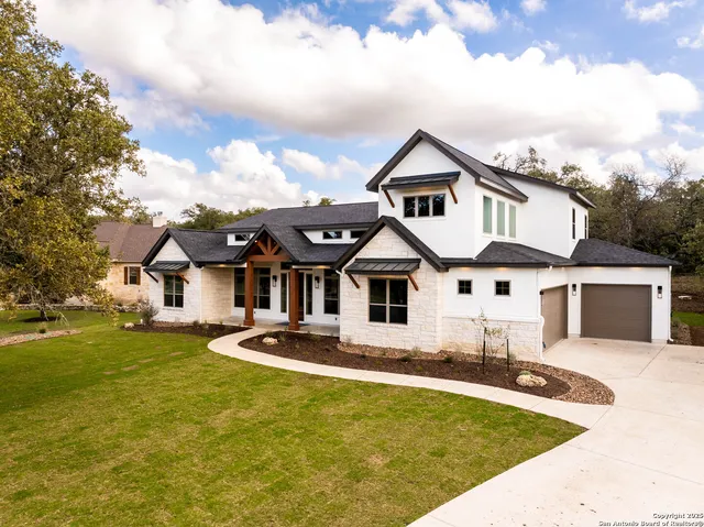 a front view of house with yard and trees