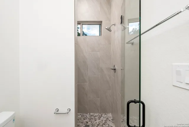 a bedroom with a bed and a large window