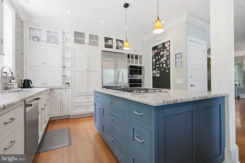 a spacious bathroom with a granite countertop double vanity sink a mirror and shower
