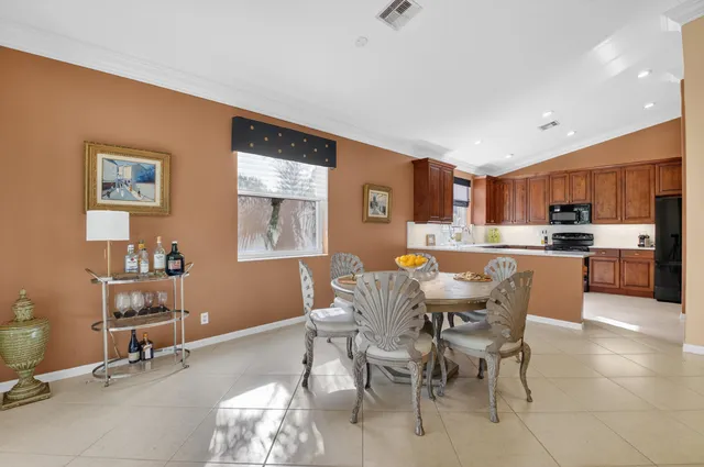 a kitchen with granite countertop wooden cabinets stainless steel appliances and a sink