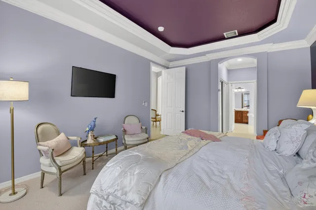 an outdoor living room with patio furniture and a garden