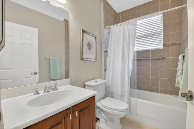 a front view of a house with a yard and fountain