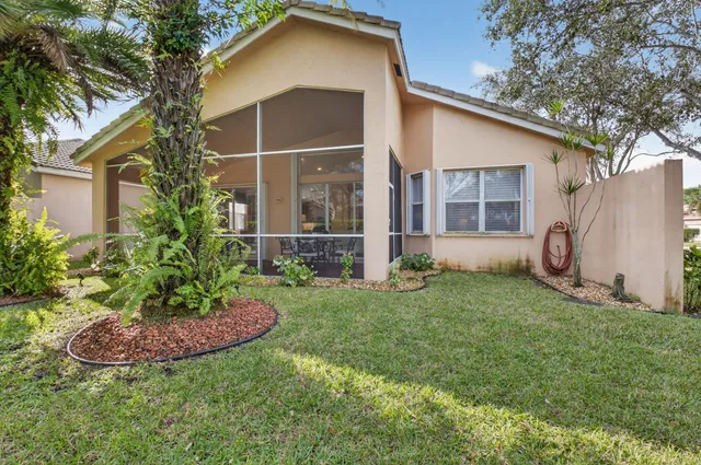 an aerial view of a house with a garden and swimming pool