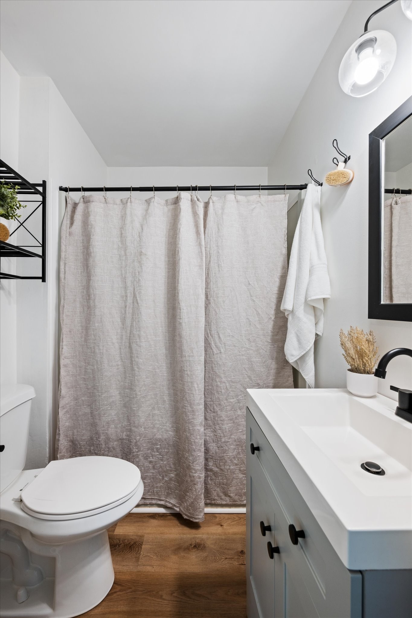 708 Oneida Avenue Nashville, TN 37207 - Photo 8 of 20 a bathroom with a sink a toilet and shower curtain