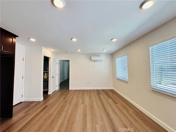 a view of hallway with wooden floor