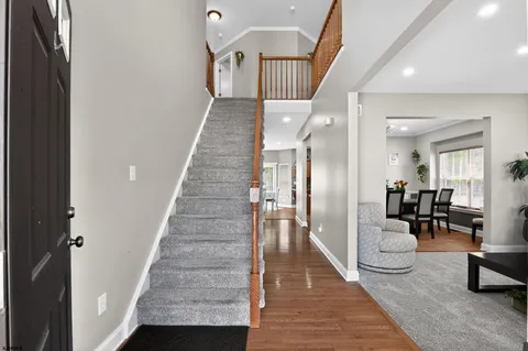 a view of entryway and hall with wooden floor