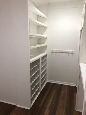 a view of walk in closet with empty racks
