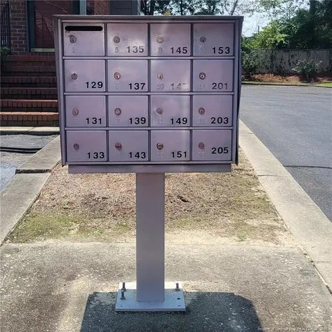 a front view of a house with a yard and potted plants