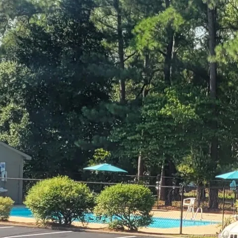 two white toilet sitting next to a bathroom sink