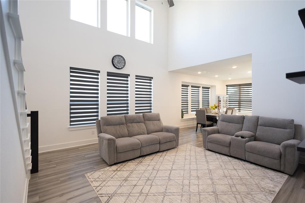 3017 Andorra Road McKinney, TX 75071 - Photo 8 of 40 High ceilings with upper windows, wood-finish flooring, and integrated window treatments