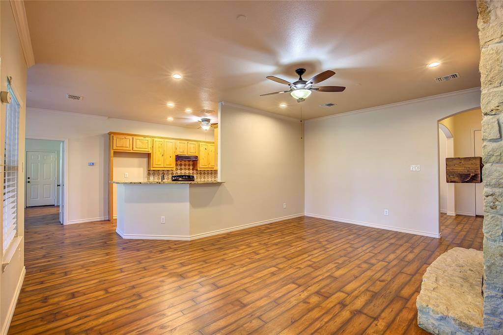2617 Kirby Road Rowlett, TX 75088 - Photo 7 of 39 Unfurnished living room with crown molding, arched walkways, recessed lighting, dark wood finished floors, and a ceiling fan