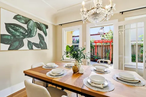 a view of a dining room with furniture wooden floor and a chandelier