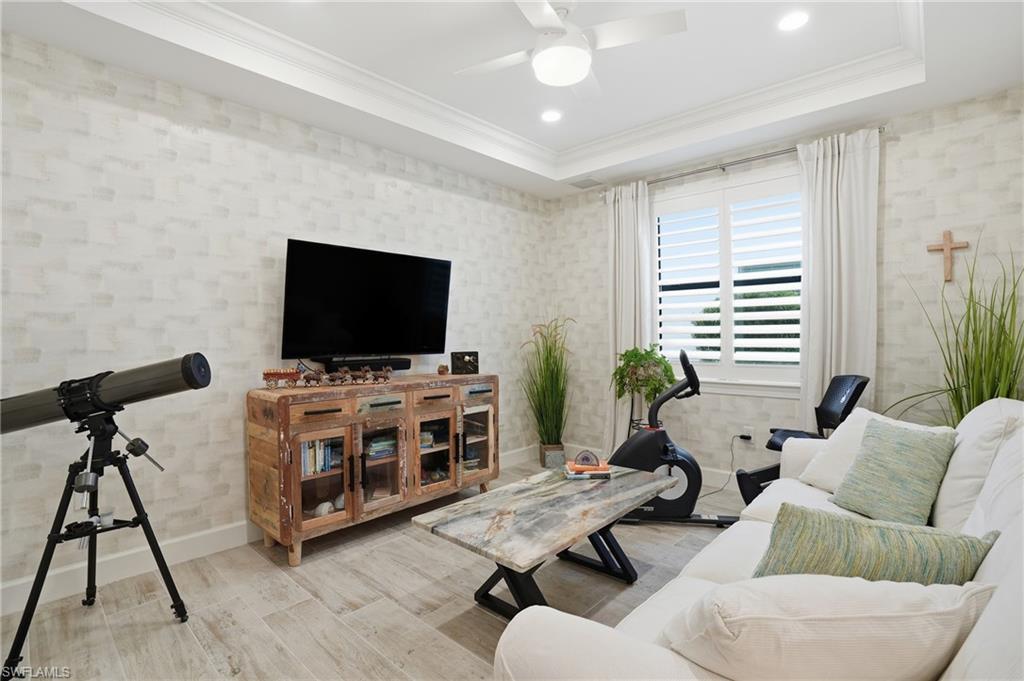 17210 Ashcomb Way Estero, FL 33928 - Photo 15 of 47 a living room with furniture and a flat screen tv