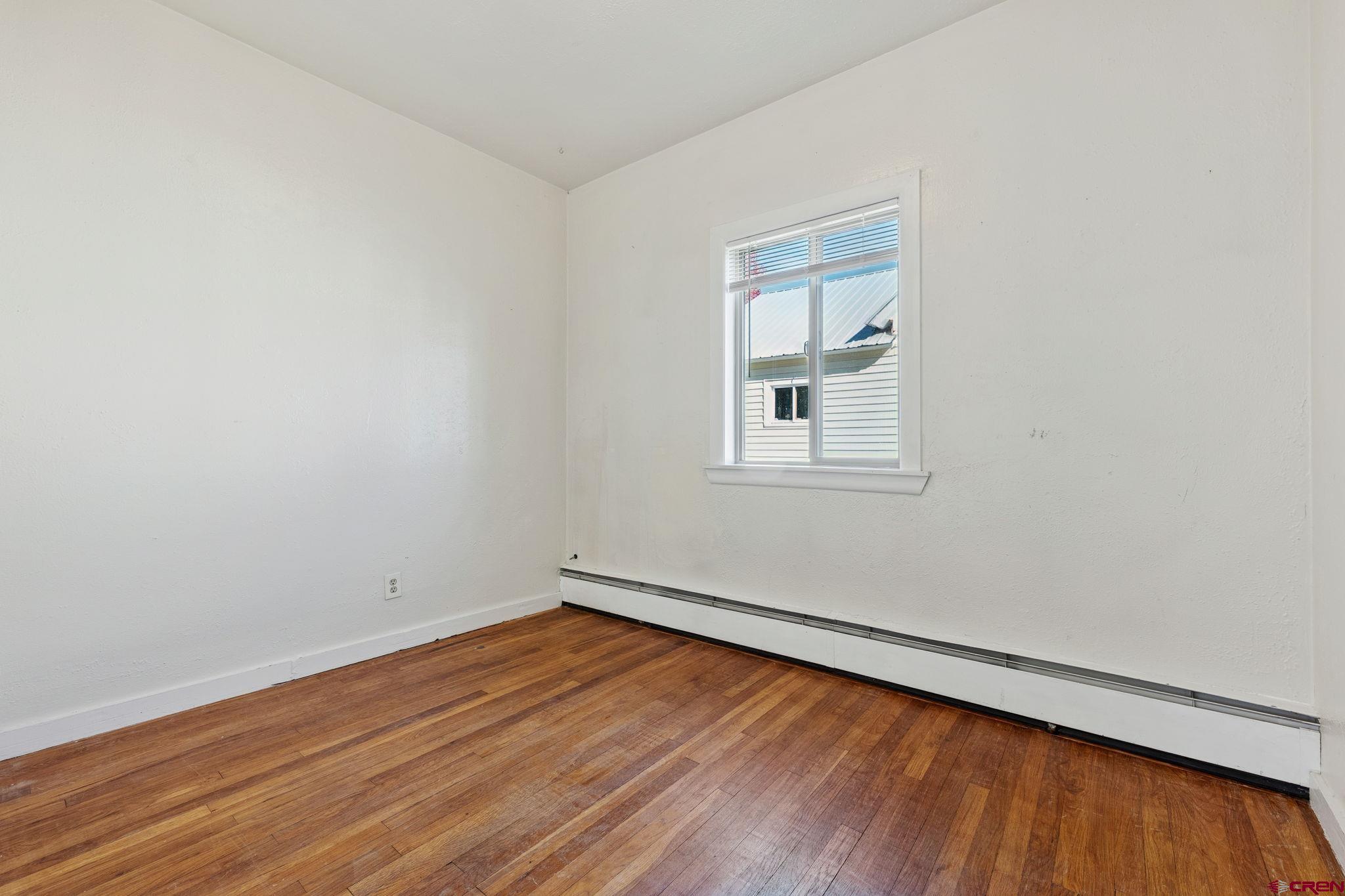 1840 West 3rd Avenue Durango, CO 81301 - Photo 12 of 33 an empty room with wooden floor and windows