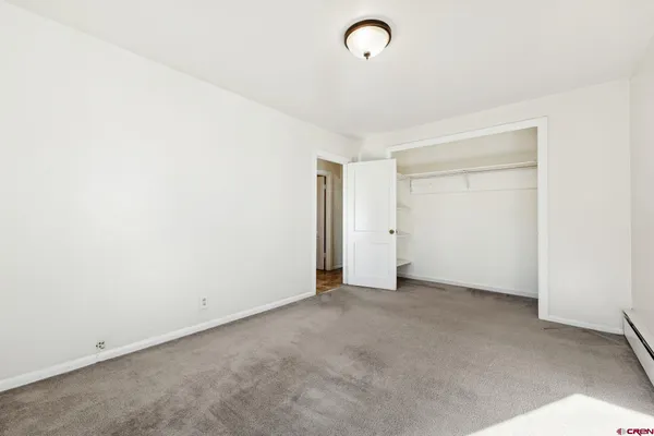 a kitchen with a refrigerator sink stove and a window