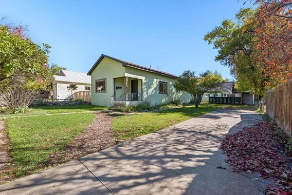 a front view of house with yard and green space