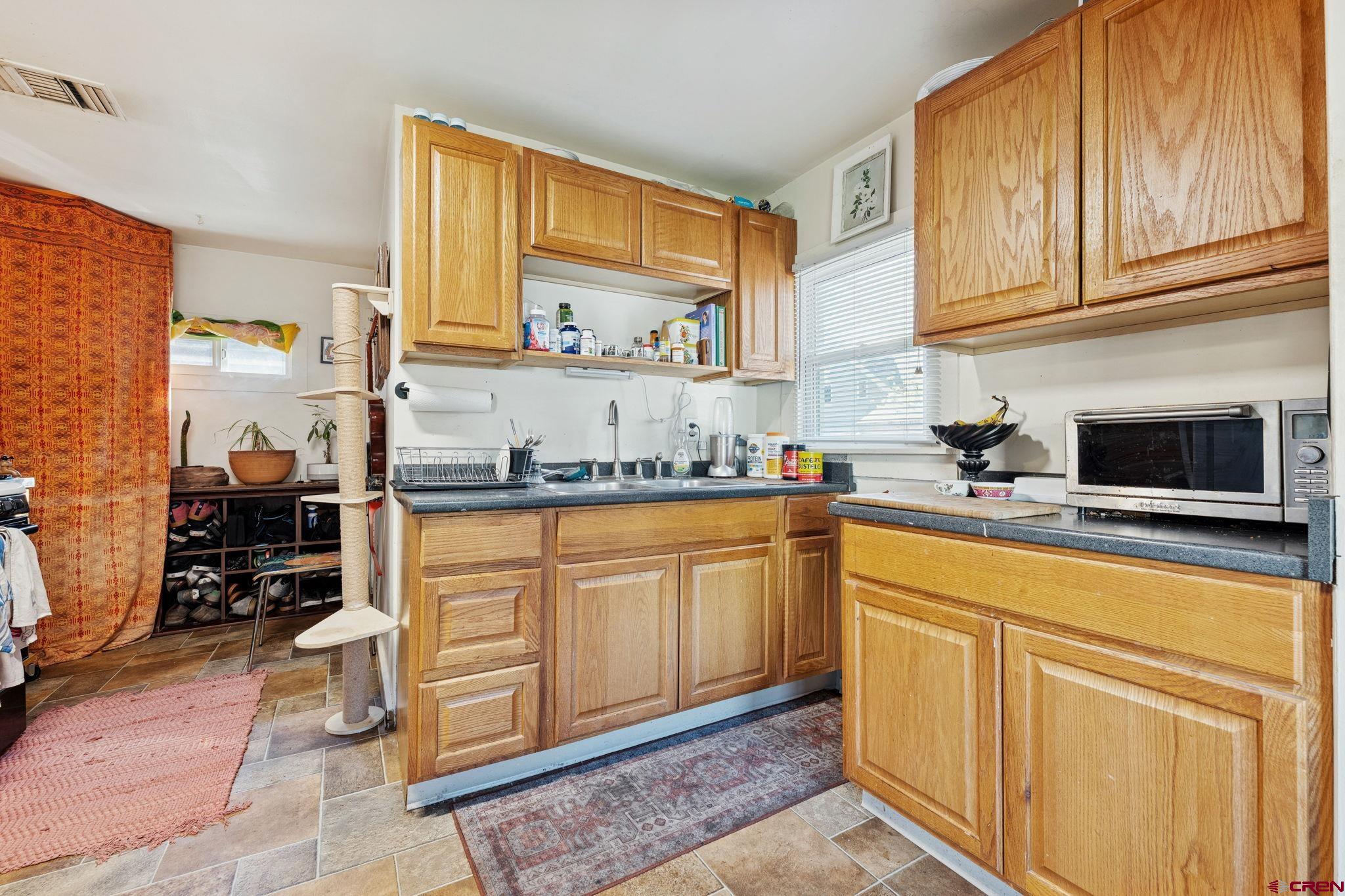 1840 West 3rd Avenue Durango, CO 81301 - Photo 29 of 32 a kitchen with stainless steel appliances granite countertop a stove a sink and a microwave