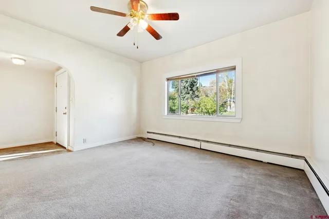 a bedroom with a large bed and a potted plant