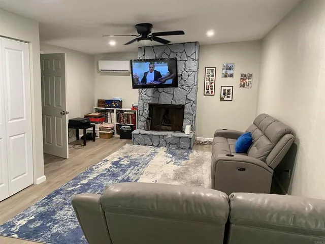 a living room with furniture and a fireplace