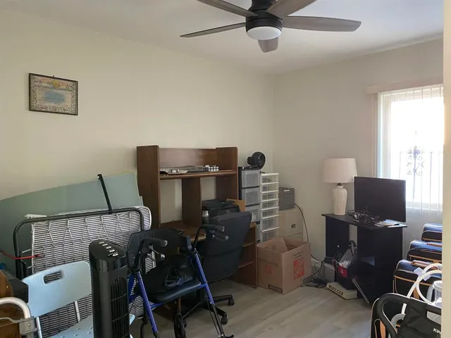 a view of workspace with wooden floor windows