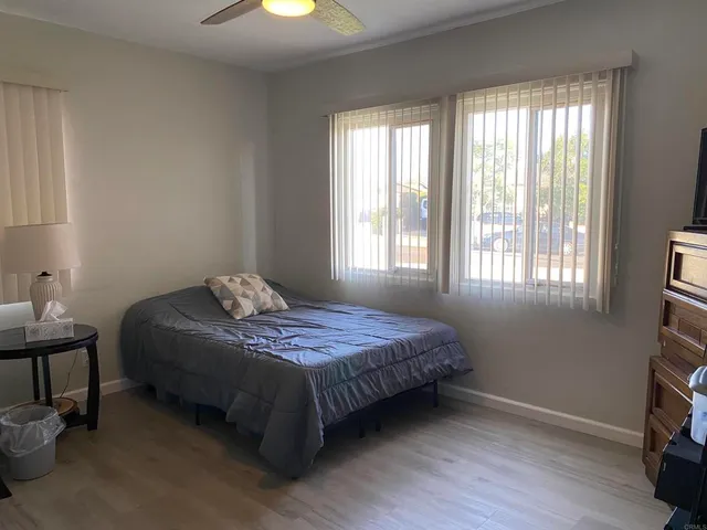 a bedroom with a bed and a window