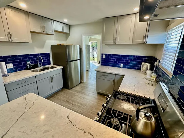 a kitchen with a stove and a refrigerator