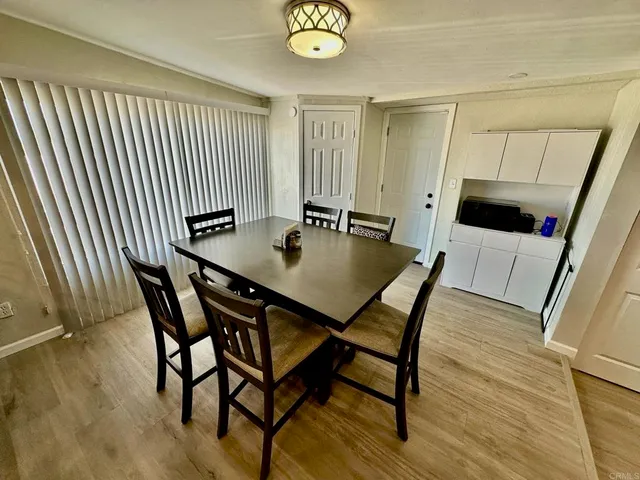 a view of a dining room with furniture and window