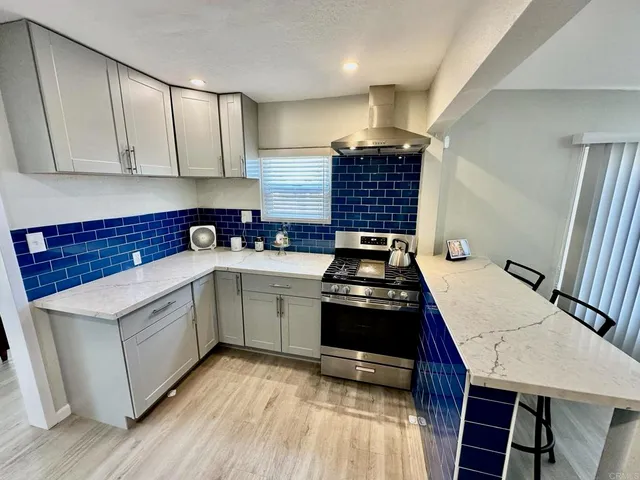 a kitchen with a sink a stove and cabinets