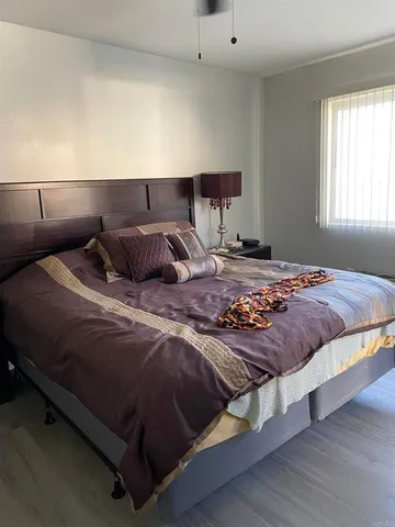 a bedroom with a bed and window