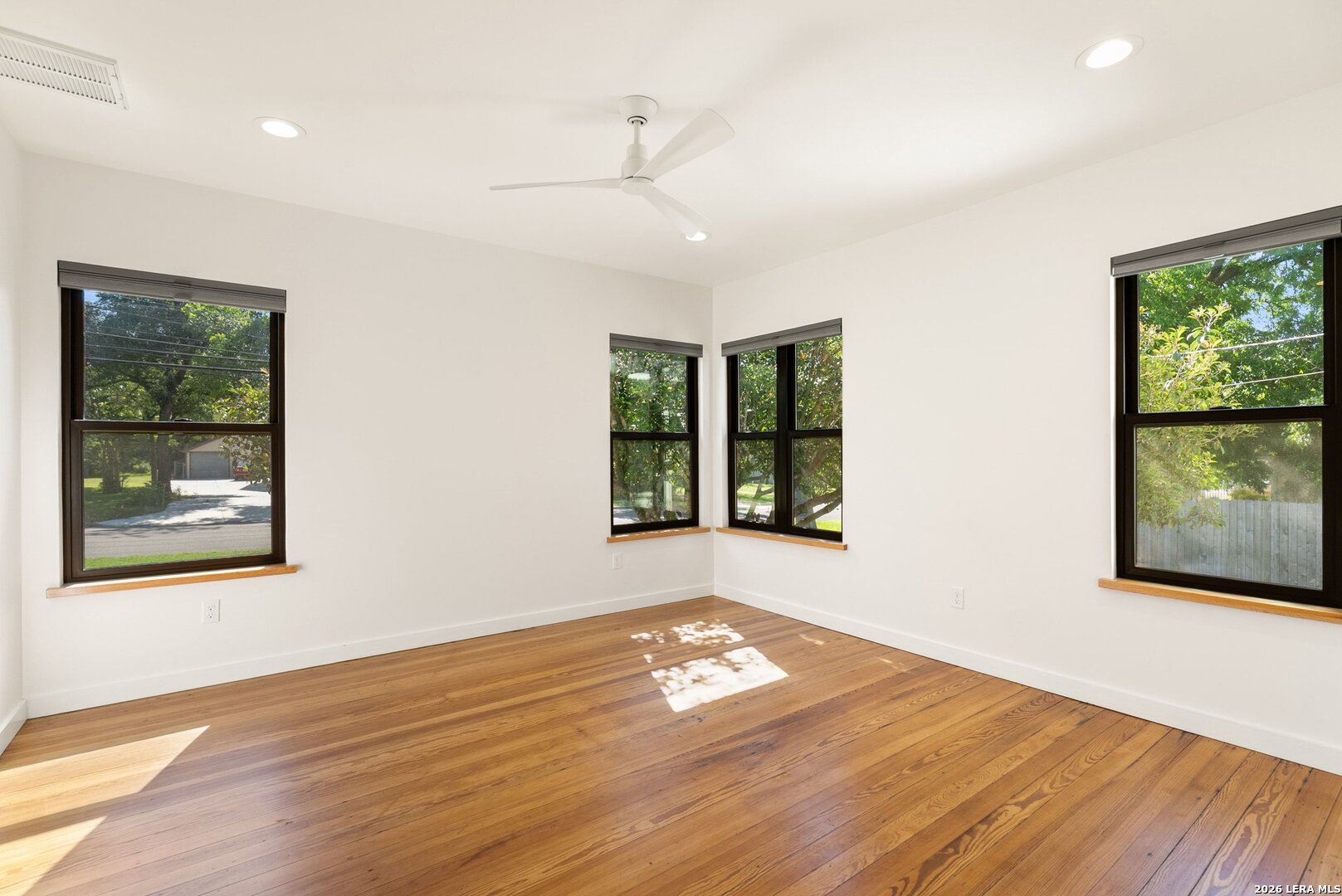 1402 Hutto Road Georgetown, TX 78626 - Photo 21 of 34 a view of an empty room with wooden floor and window