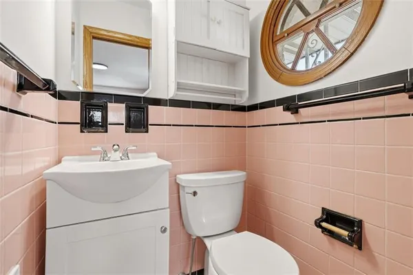 a bathroom with a toilet a sink and a mirror