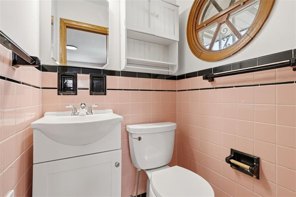 431 Colonial Drive Monroeville, PA 15146 - Photo 12 of 28 a bathroom with a toilet a sink and a mirror