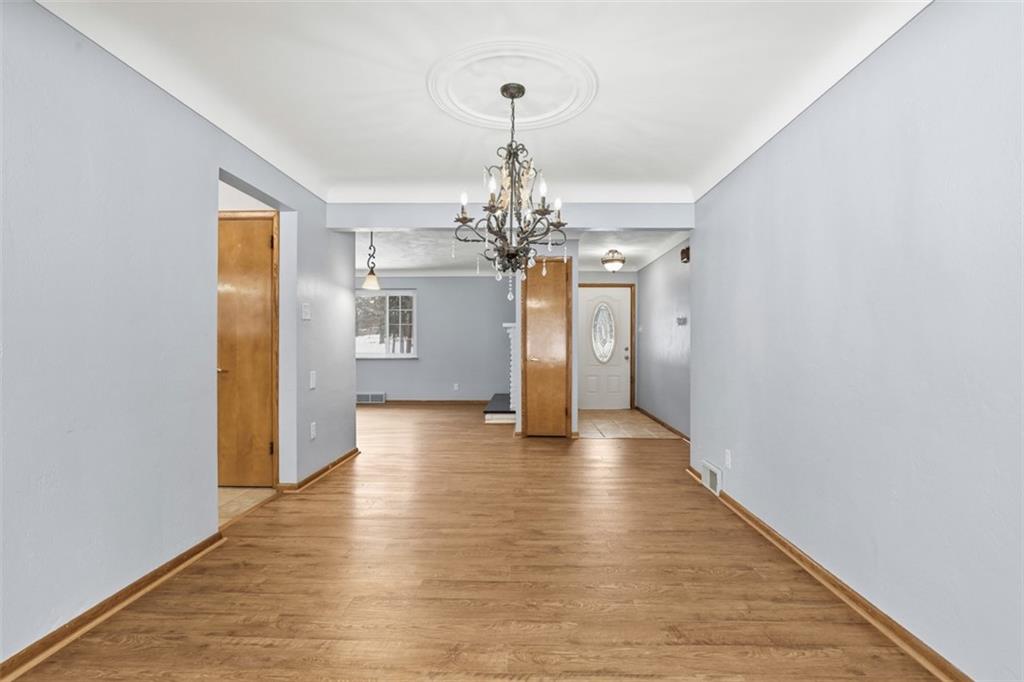 431 Colonial Drive Monroeville, PA 15146 - Photo 18 of 28 a view of a hallway with wooden floor and a chandelier