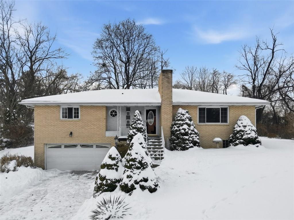 431 Colonial Drive Monroeville, PA 15146 - Photo 2 of 28 a front view of a house with a yard and garage