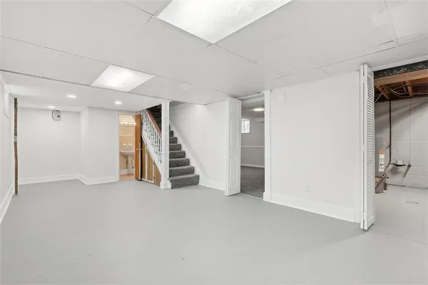 an empty room with wooden floor and stairs