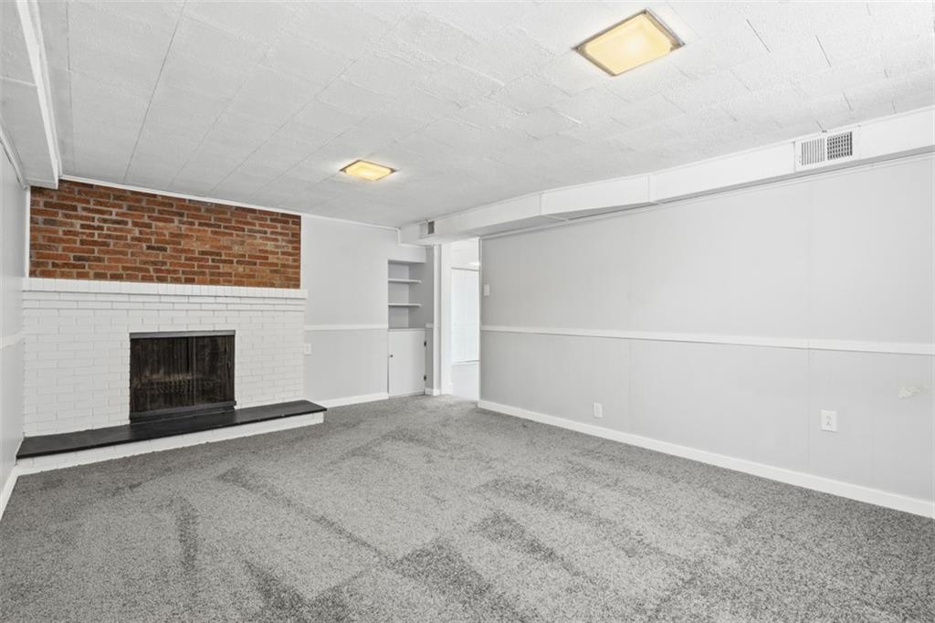 431 Colonial Drive Monroeville, PA 15146 - Photo 23 of 28 a view of an empty room with a fireplace and a window