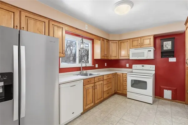 a kitchen with stainless steel appliances granite countertop a refrigerator and a sink