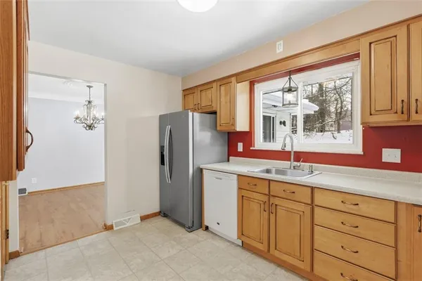 a kitchen with cabinets a refrigerator and a sink
