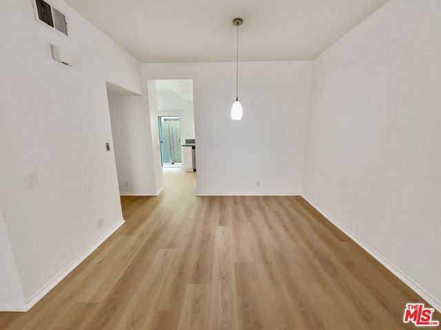 a view of a room with wooden floor and window