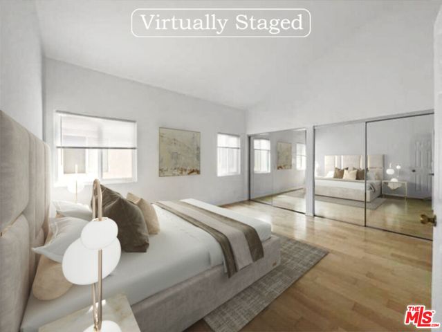 a spacious bedroom with a bed and window