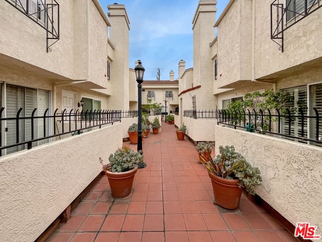 a view of a patio with couches and potted plants
