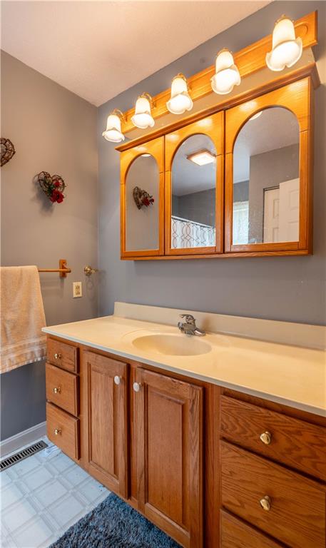 4487 Battle Ridge Road Oakdale, PA 15071 - Photo 25 of 46 a bathroom with a sink a vanity and a large mirror