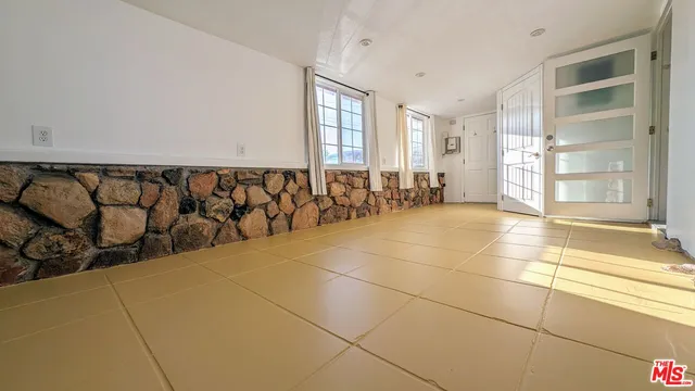 a view of a livingroom with an entryway and a window