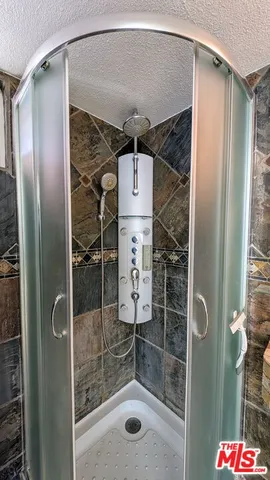 a bathroom with a shower and a sink