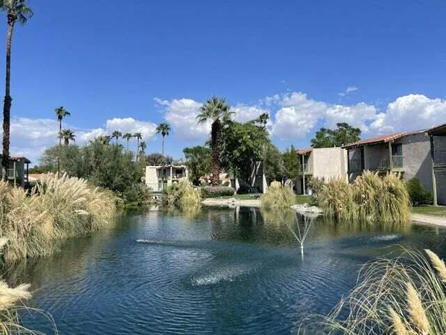 a view of a swimming pool with outdoor seating